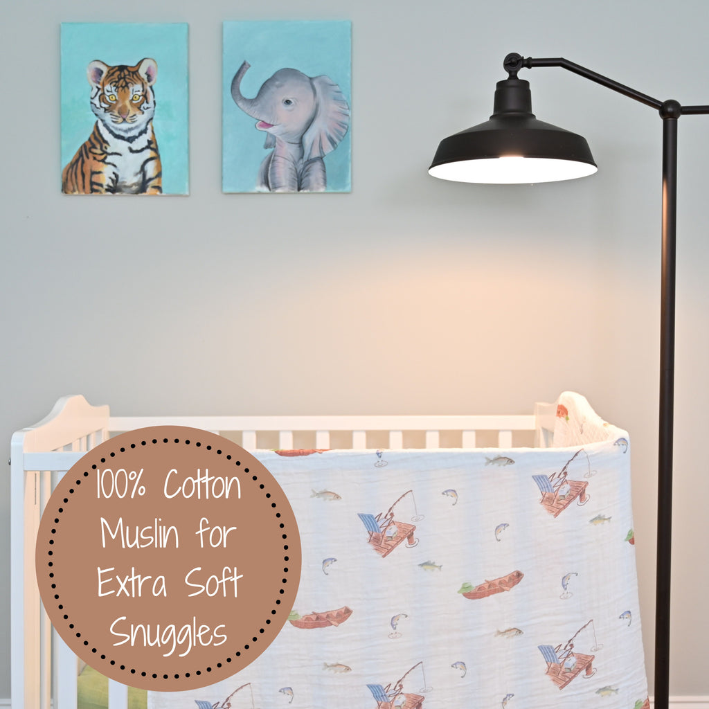 The Go Fishing Adventure 100% Muslin Cotton Swaddle Blanket - 47" x 47" gracefully draped on a crib, infusing a sense of outdoor adventure into the nursery.